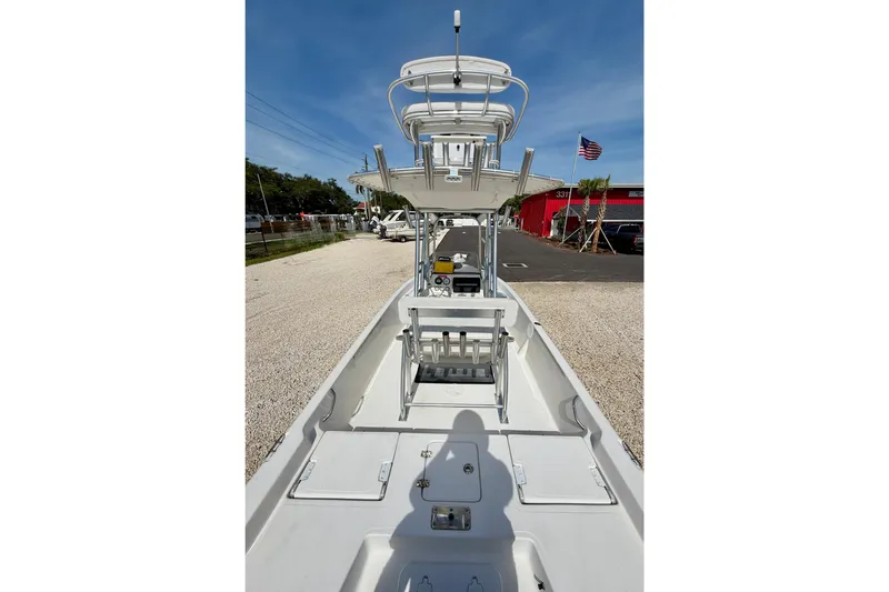 Slide: The Image of 2010 NauticStar 2110 Nautic Bay boat with T-top, parked on gravel lot. - 25
