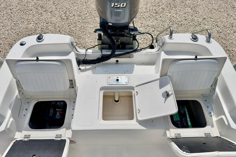 Slide: The Image of 2010 NauticStar 2110 Nautic Bay boat with Yamaha 150 engine, open storage compartments. - 27