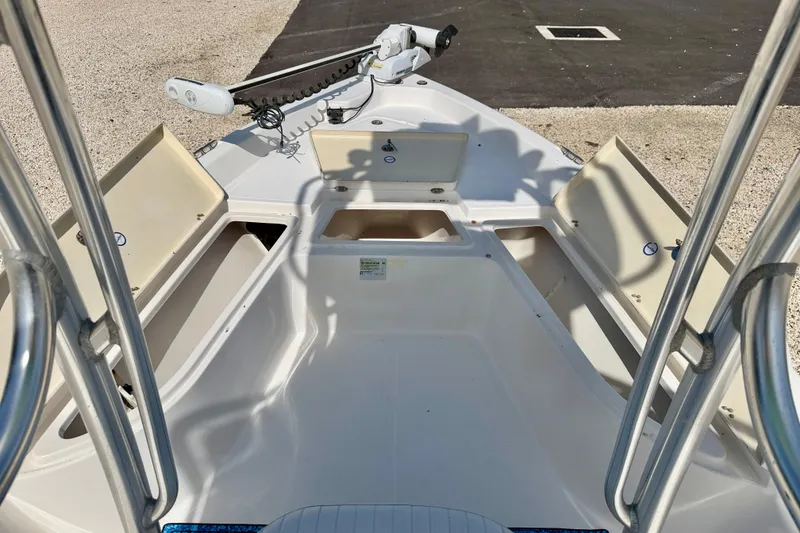 Slide: The Image of 2010 NauticStar 2110 Nautic Bay boat deck with open storage compartments and trolling motor. - 29