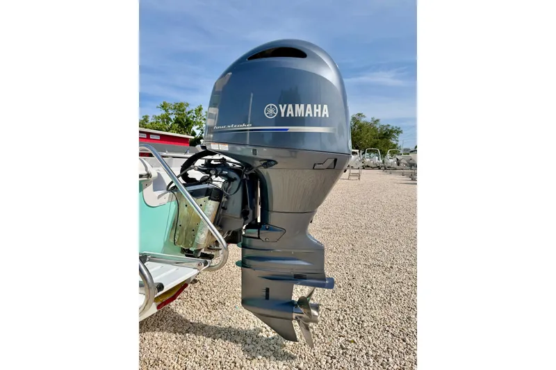 Slide: The Image of 2010 NauticStar 2110 Nautic Bay with Yamaha outboard motor on gravel lot. - 35