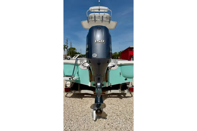 Slide: The Image of 2010 NauticStar 2110 Nautic Bay boat with Yamaha 150 outboard motor, parked on gravel. - 36