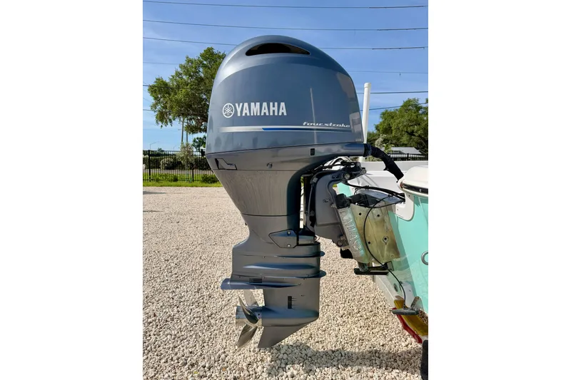 Slide: The Image of Yamaha outboard motor on 2010 NauticStar 2110 Nautic Bay boat, parked on gravel. - 37