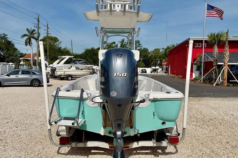 Slide: The Image of 2010 NauticStar 2110 Nautic Bay boat with Yamaha 150 engine, parked outdoors. - 6