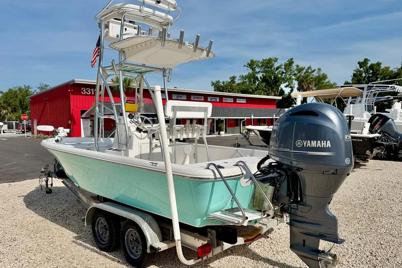 Slide: The Image of 2010 NauticStar 2110 Nautic Bay boat with Yamaha engine on trailer, parked outdoors. - 7