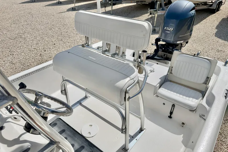 Slide: The Image of 2010 NauticStar 2110 Nautic Bay boat interior with seating and steering wheel. - 9