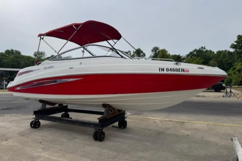 The Image of 2008 Yamaha Boats SX230 HO with red and white design on a trailer. - 0