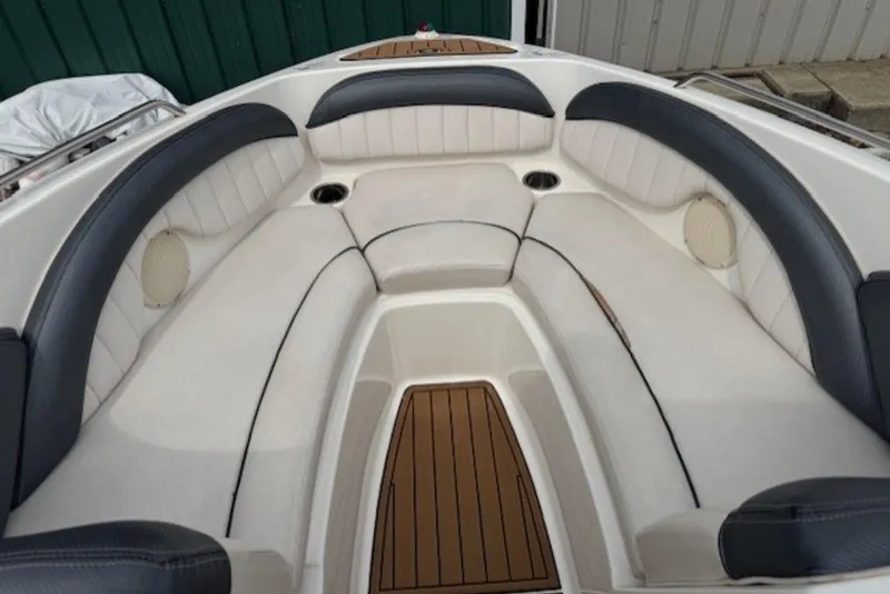 Slide: The Image of 2008 Yamaha Boats SX230 HO interior with cushioned seating and wood accents. - 12