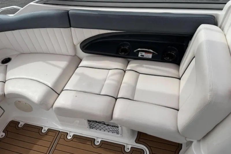 Slide: The Image of 2008 Yamaha Boats SX230 HO interior seating with white upholstery and cup holders. - 17