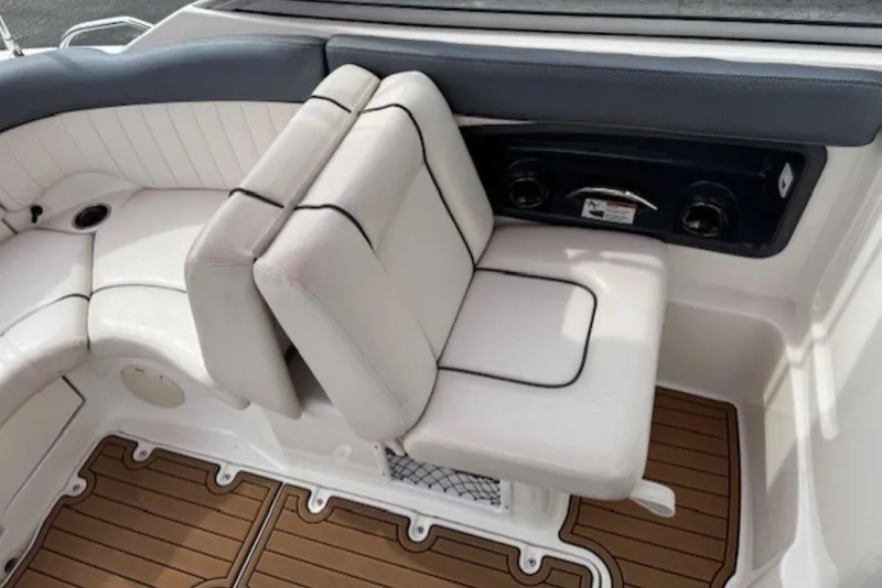 Slide: The Image of 2008 Yamaha Boats SX230 HO interior seating with white upholstery and wood-style flooring. - 18