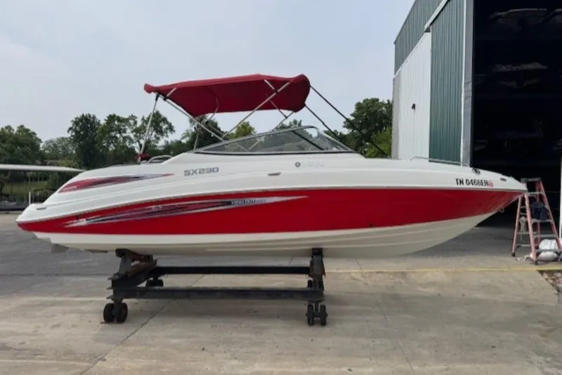 Slide: The Image of 2008 Yamaha Boats SX230 HO with red accents and canopy, parked outdoors. - 2