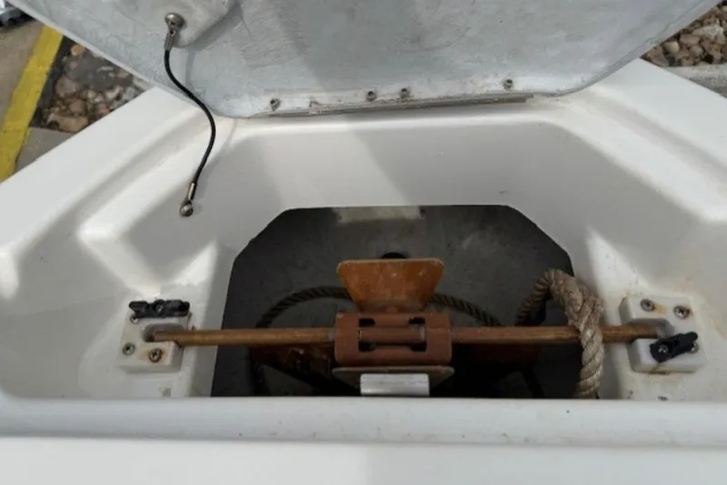Slide: The Image of Open anchor compartment of 2008 Yamaha Boats SX230 HO with visible rope and mechanism. - 26