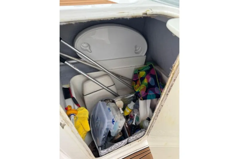 Slide: The Image of Storage compartment in a 2008 Yamaha Boats SX230 HO, filled with various boating accessories. - 28