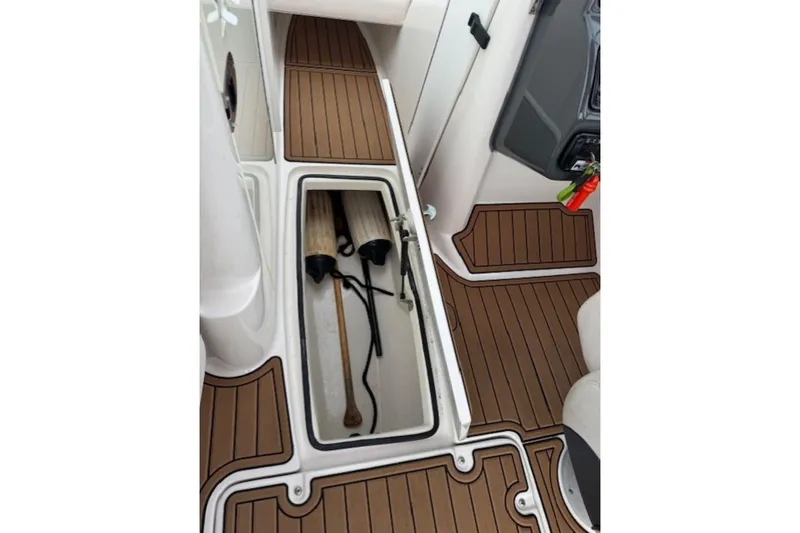 Slide: The Image of 2008 Yamaha Boats SX230 HO interior storage compartment with wooden flooring and accessories. - 29
