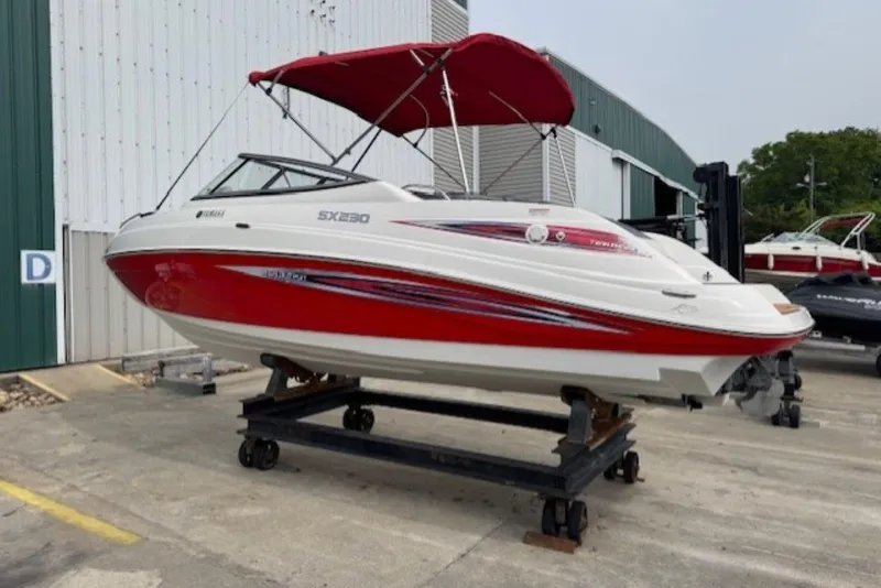 Slide: The Image of 2008 Yamaha Boats SX230 HO with red accents on display outside a warehouse. - 3