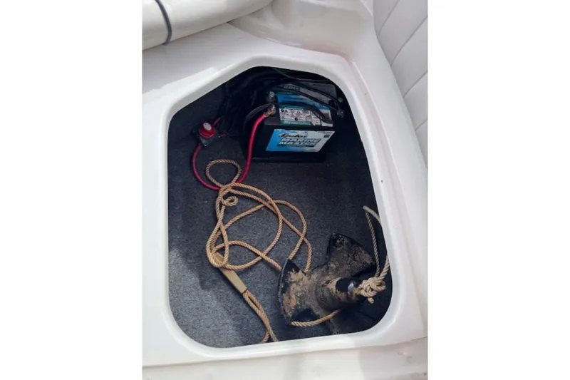 Slide: The Image of Storage compartment of a 2008 Yamaha SX230 HO boat with battery and anchor. - 34