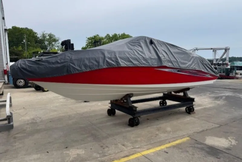 Slide: The Image of 2008 Yamaha Boats SX230 HO covered, red and white hull, on trailer at marina. - 35