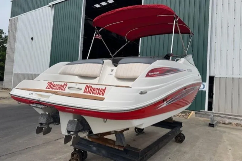 Slide: The Image of 2008 Yamaha Boats SX230 HO with red canopy, docked outside a warehouse. - 5