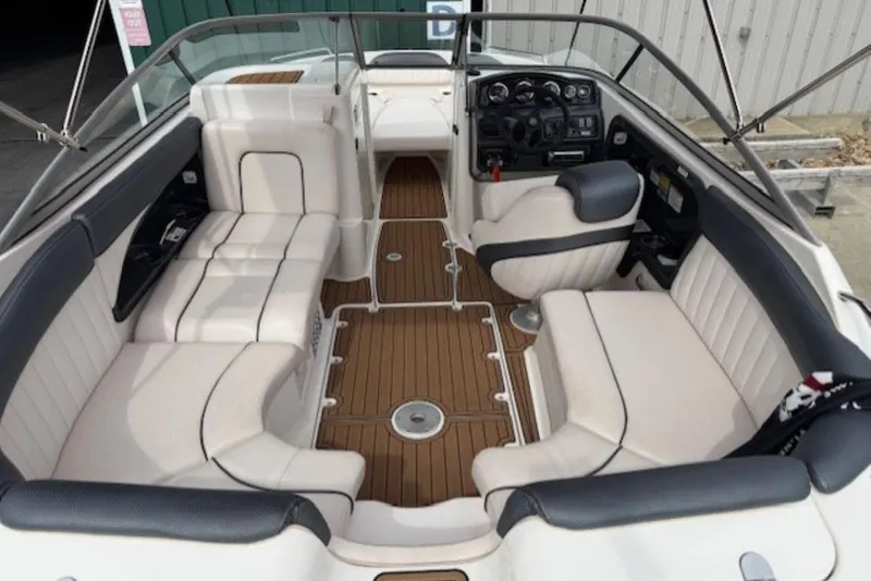 Slide: The Image of 2008 Yamaha Boats SX230 HO interior with white seating and wood-style flooring. - 9