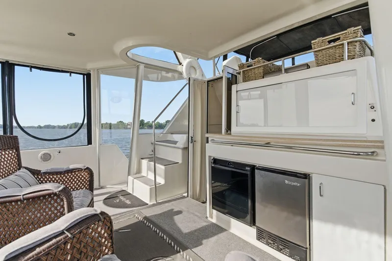 Slide: The Image of Interior of 1998 Carver 445 Aft Cabin Motor Yacht with seating and kitchenette. - 10