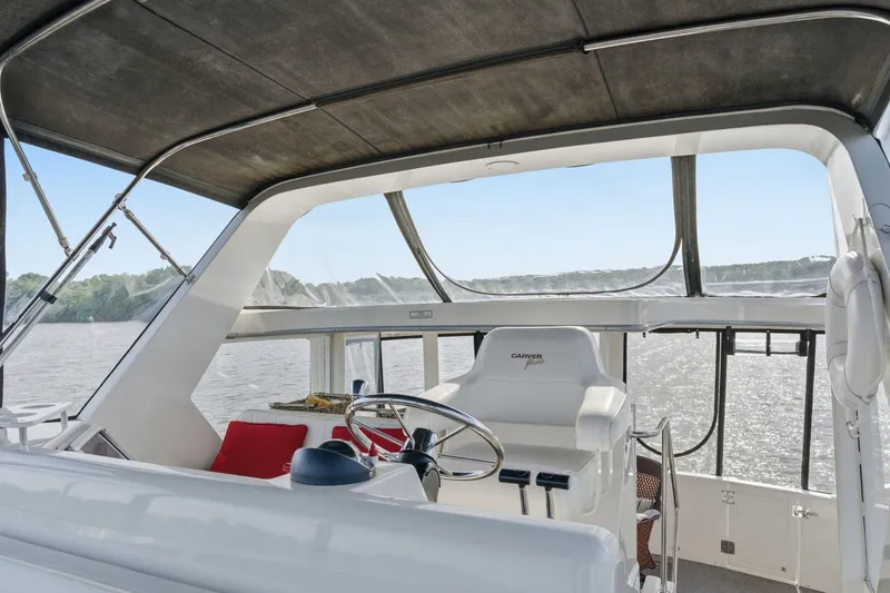 Slide: The Image of 1998 Carver 445 Aft Cabin Motor Yacht helm with panoramic water view. - 11