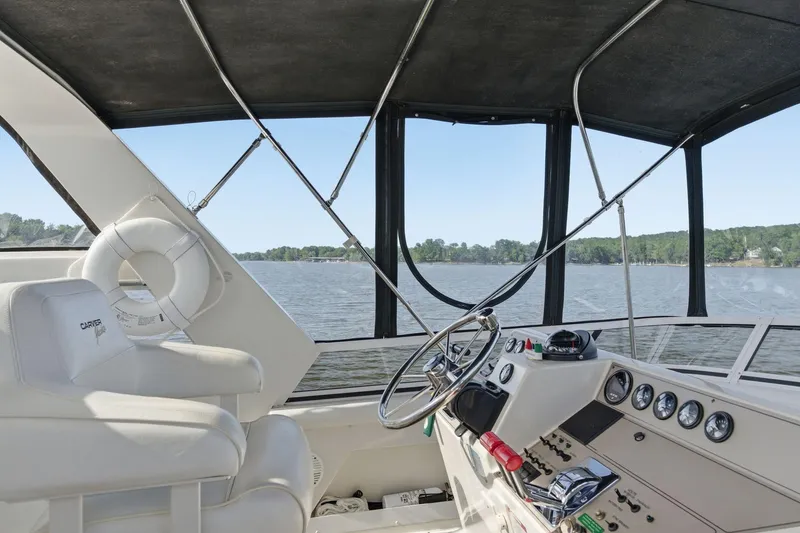 Slide: The Image of 1998 Carver 445 Aft Cabin Motor Yacht helm with panoramic water view. - 12