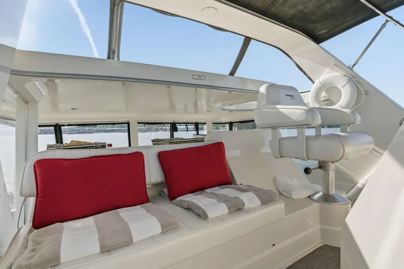 Slide: The Image of 1998 Carver 445 Aft Cabin Motor Yacht interior with red cushions and captain's chair. - 14