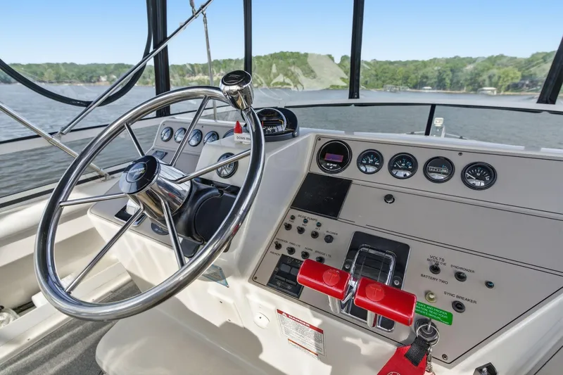 Slide: The Image of Helm of 1998 Carver 445 Aft Cabin Motor Yacht with steering wheel and control panel. - 15