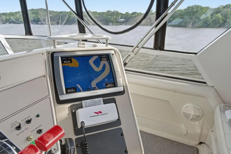 Slide: The Image of 1998 Carver 445 Aft Cabin Motor Yacht helm with Garmin navigation system on river. - 17