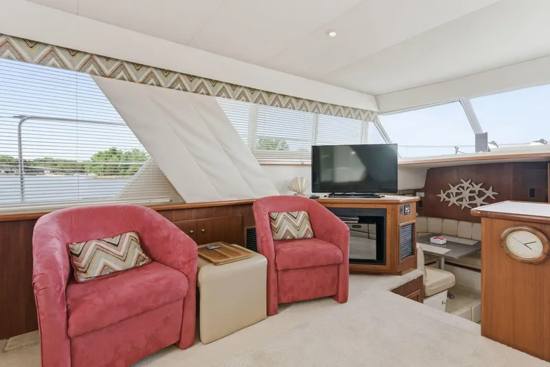 Slide: The Image of Interior of 1998 Carver 445 Aft Cabin Motor Yacht with plush seating and TV. - 19