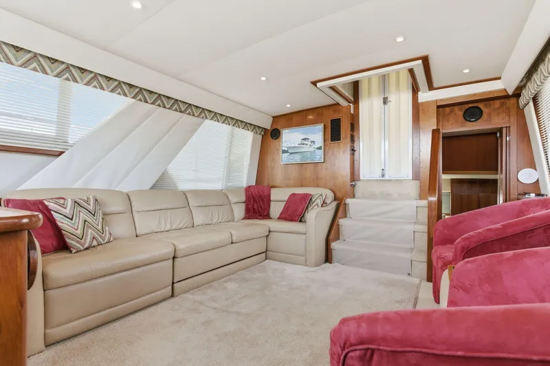 Slide: The Image of Luxurious interior of 1998 Carver 445 Aft Cabin Motor Yacht with beige seating and red accents. - 22