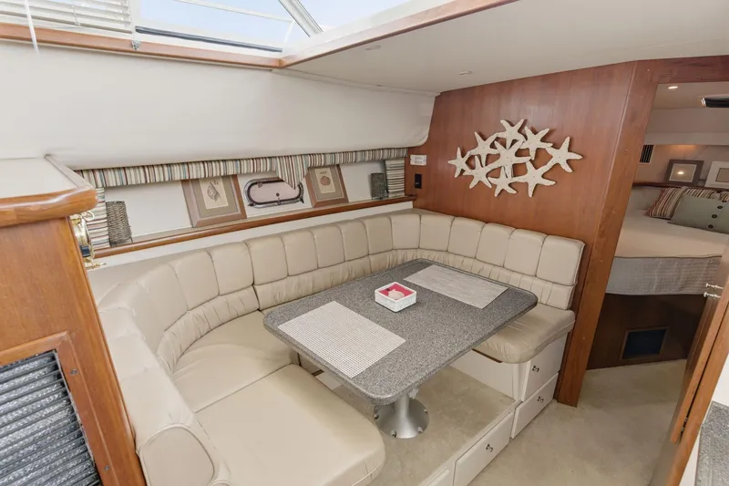 Slide: The Image of Interior of 1998 Carver 445 Aft Cabin Motor Yacht with cozy dining area and starfish decor. - 23