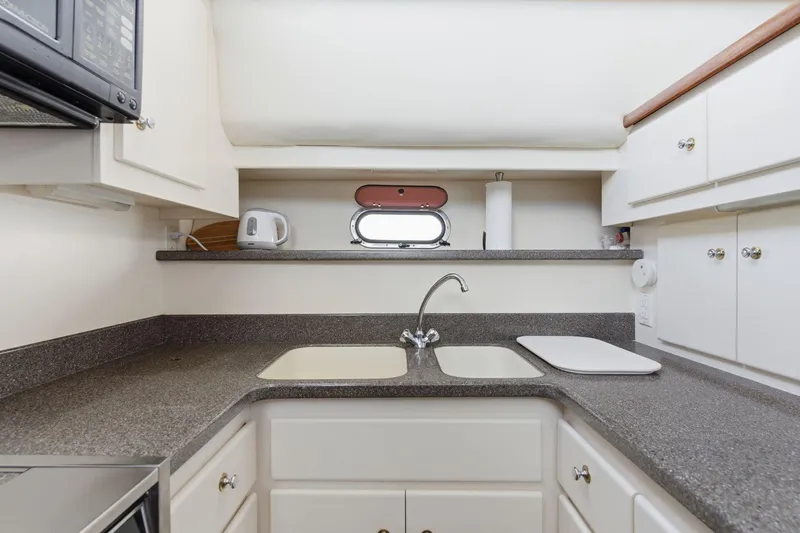Slide: The Image of Compact kitchen in 1998 Carver 445 Aft Cabin Motor Yacht with sink and countertop. - 25