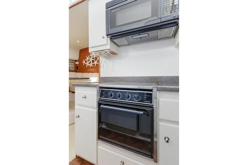 Slide: The Image of 1998 Carver 445 Aft Cabin Motor Yacht kitchen with microwave and oven. - 26