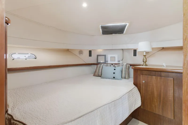 Slide: The Image of Cozy bedroom in 1998 Carver 445 Aft Cabin Motor Yacht with elegant decor. - 28