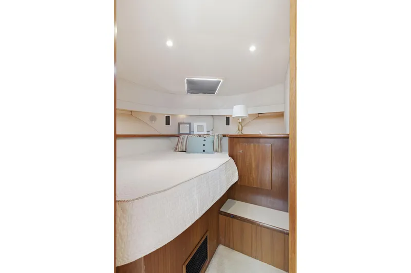 Slide: The Image of 1998 Carver 445 Aft Cabin Motor Yacht interior cabin with bed and wooden accents. - 29