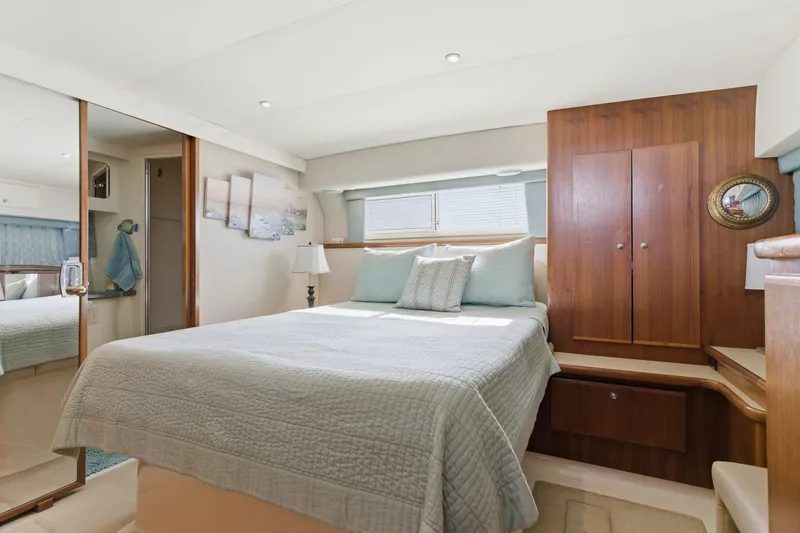 Slide: The Image of Luxurious bedroom interior of 1998 Carver 445 Aft Cabin Motor Yacht with elegant wood finishes. - 33