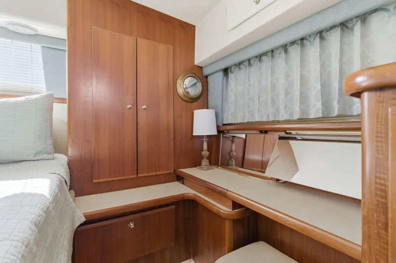 Slide: The Image of Interior of 1998 Carver 445 Aft Cabin Motor Yacht with wood cabinetry and cozy decor. - 35