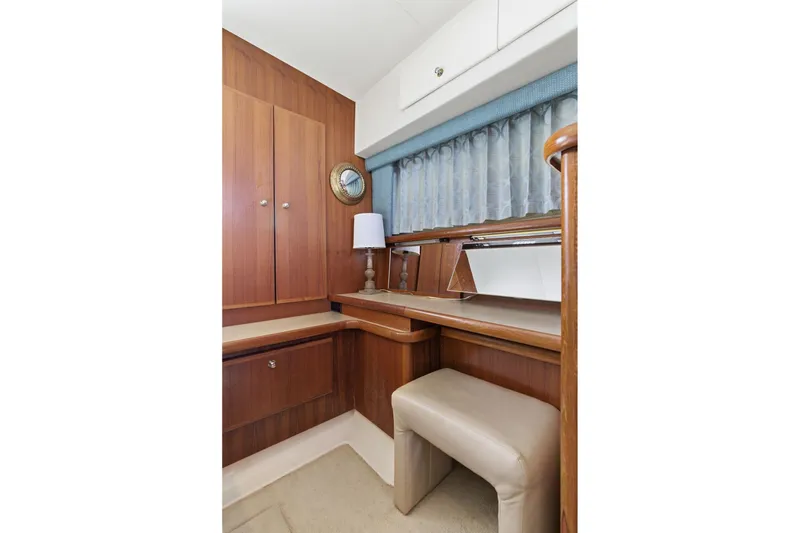 Slide: The Image of 1998 Carver 445 Aft Cabin Motor Yacht interior with wooden cabinetry and seating area. - 36