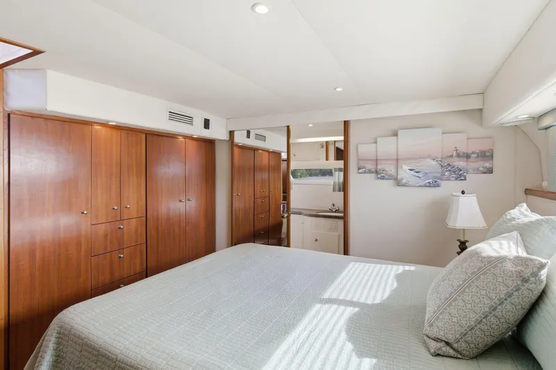 Slide: The Image of Luxurious bedroom interior of 1998 Carver 445 Aft Cabin Motor Yacht with elegant wood cabinetry. - 40