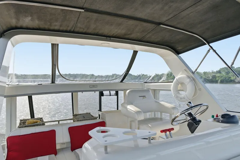 Slide: The Image of 1998 Carver 445 Aft Cabin Motor Yacht helm with scenic river view. - 42