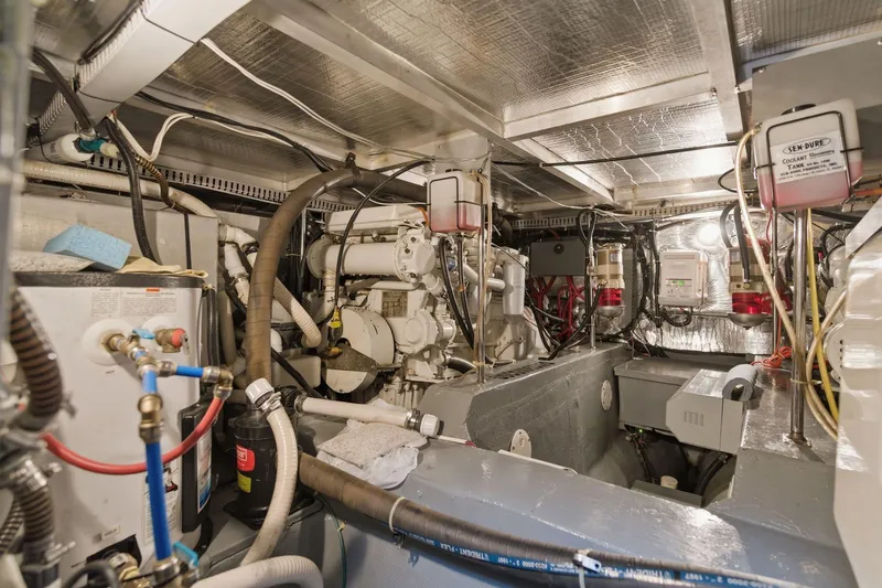 Slide: The Image of Engine room of 1998 Carver 445 Aft Cabin Motor Yacht, showcasing mechanical components and wiring. - 43