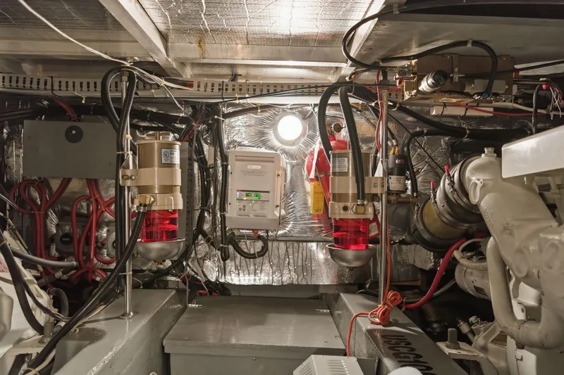 Slide: The Image of Engine room of a 1998 Carver 445 Aft Cabin Motor Yacht, showcasing mechanical components. - 49