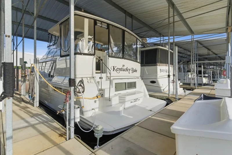 Slide: The Image of 1998 Carver 445 Aft Cabin Motor Yacht docked in a covered marina. - 51