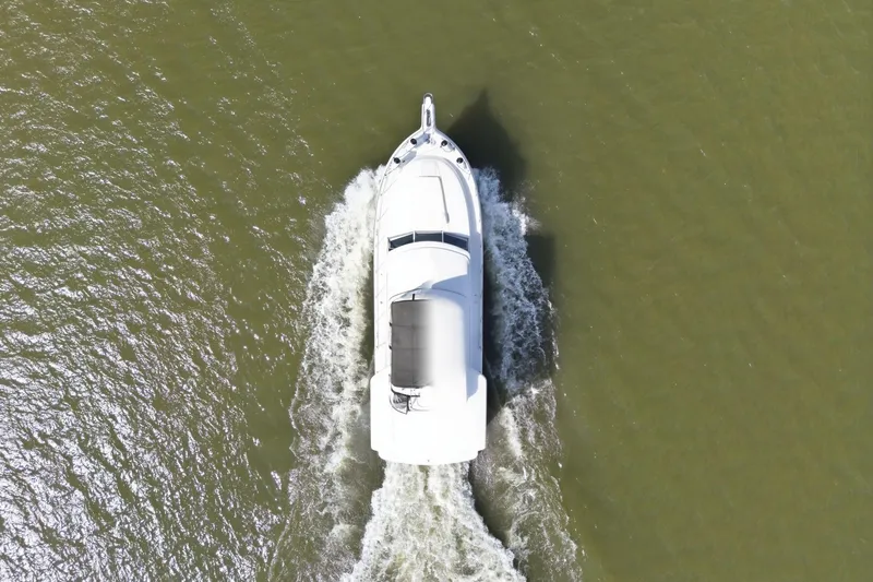 Slide: The Image of Aerial view of 1998 Carver 445 Aft Cabin Motor Yacht cruising on water. - 7