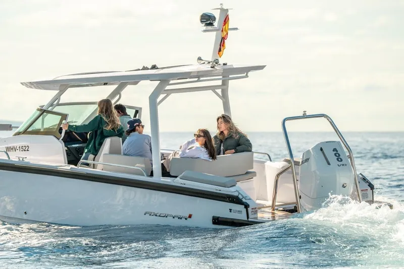 Slide: The Image of 2026 Axopar 29 Sun-Top boat cruising with passengers on a sunny day. - 3