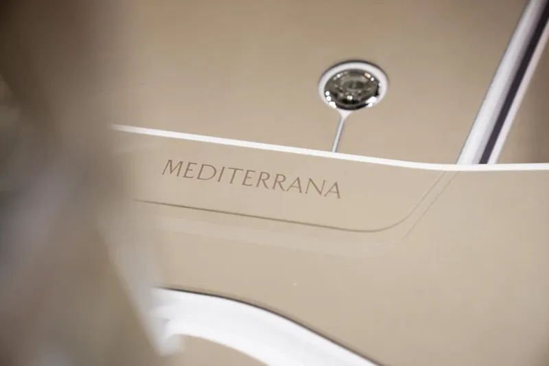 Slide: The Image of 2026 Axopar 29 Sun-Top boat with "MEDITERRANA" inscription on beige surface. - 9