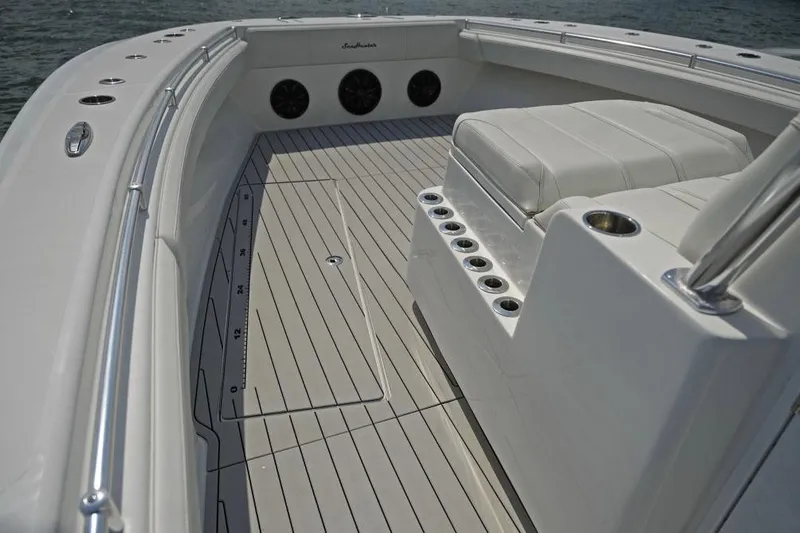 Slide: The Image of Manufacturer Provided Image: 2025 SeaHunter 38 CTS boat interior with cushioned seating and rod holders. - 3