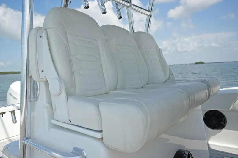 Slide: The Image of Manufacturer Provided Image: 2025 SeaHunter 38 CTS boat with white cushioned seating, ocean backdrop. - 5
