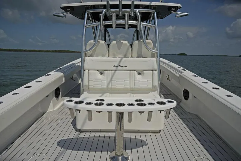 Slide: The Image of Manufacturer Provided Image: 2025 SeaHunter 38 CTS boat interior with rod holders, sleek design, and open water backdrop. - 7