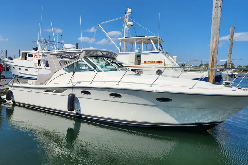 The Image of 1998 Tiara Yachts 3500 Open docked at marina under clear blue sky. - 0